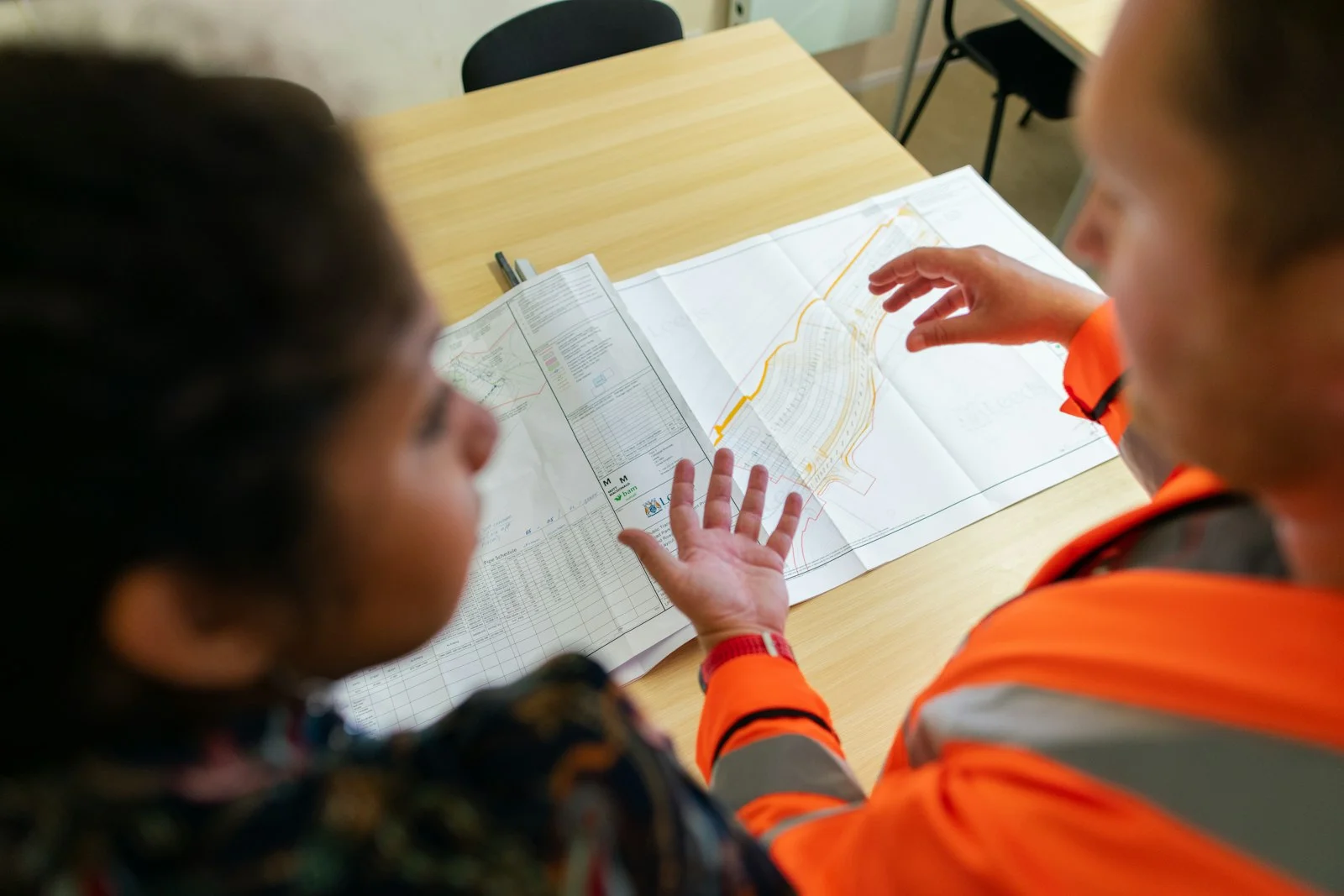 boy in orange long sleeve shirt writing on white paper boy in orange long sleeve shirt writing on white paper