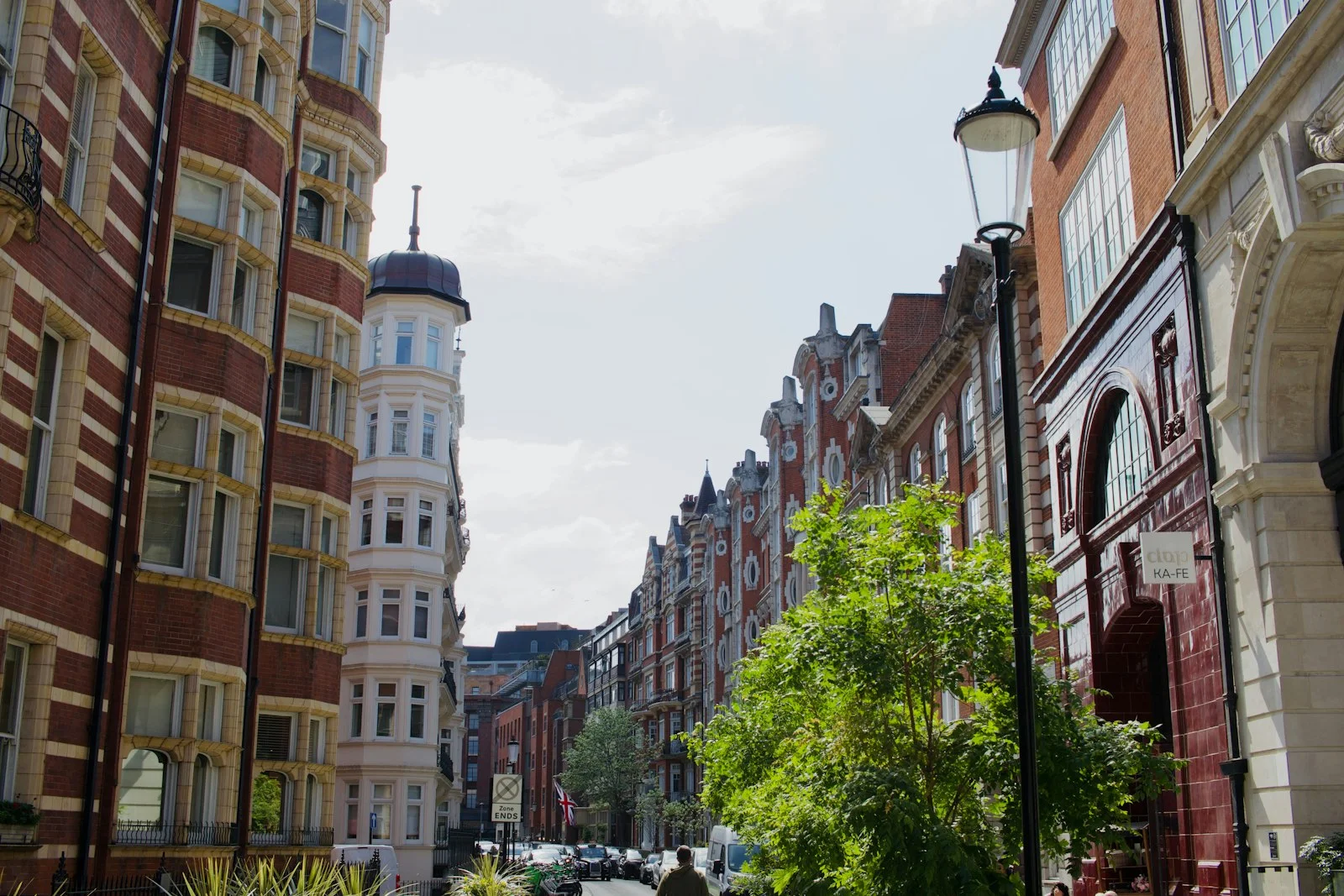 Ornate buildings line a sunny city street. Ornate buildings line a sunny city street.