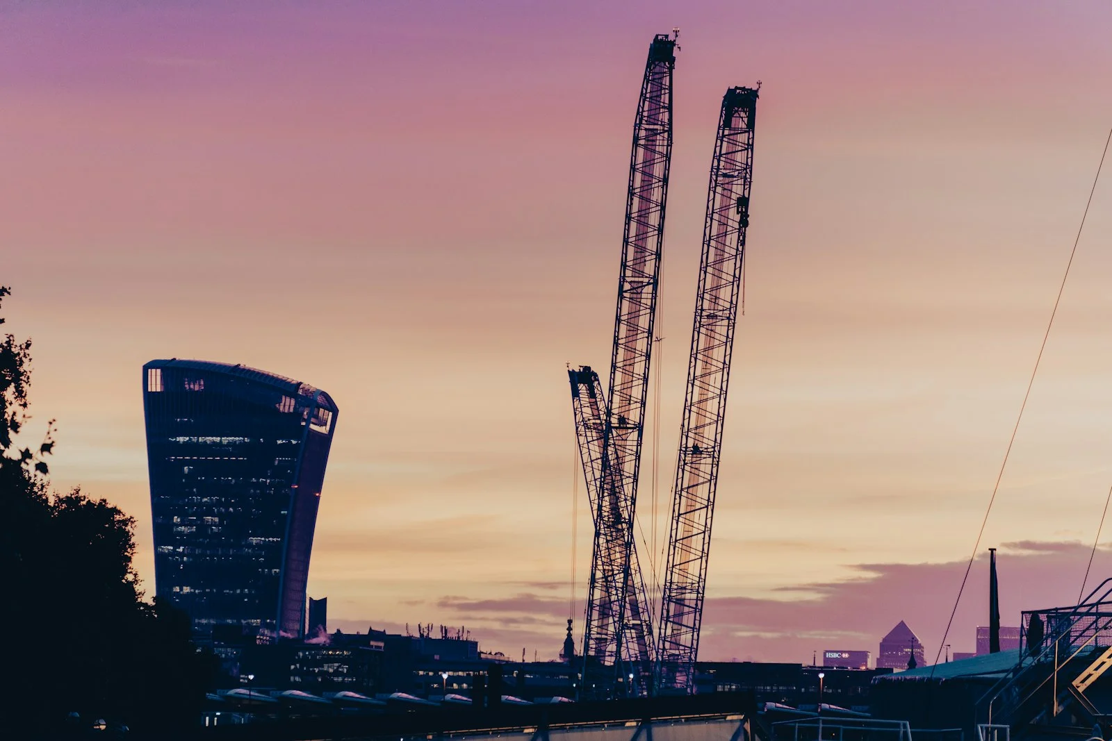London skyline at dusk with the Walkie-Talkie building and construction cranes