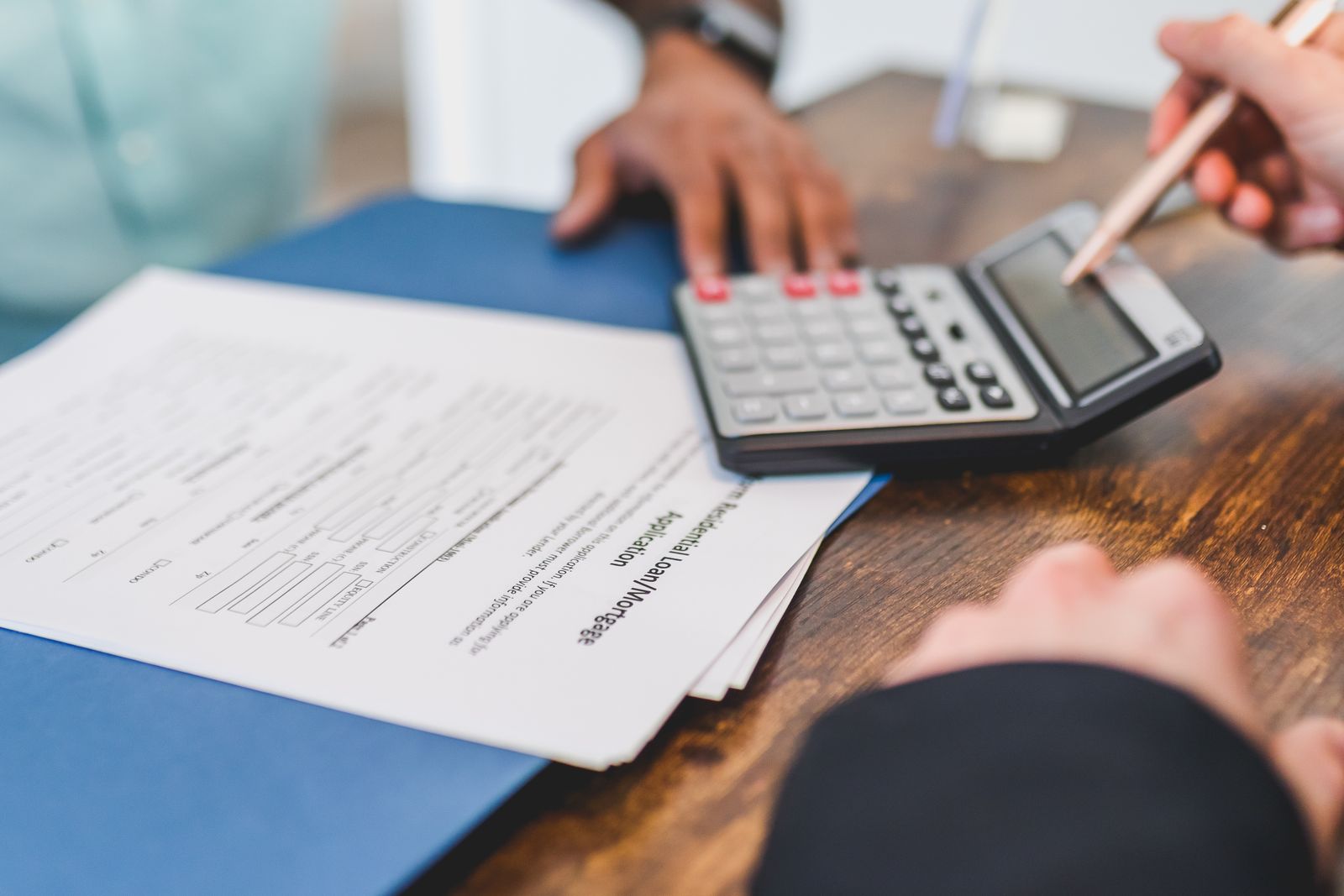 Bills and calculator sit on a desk. Bills and calculator sit on a desk.