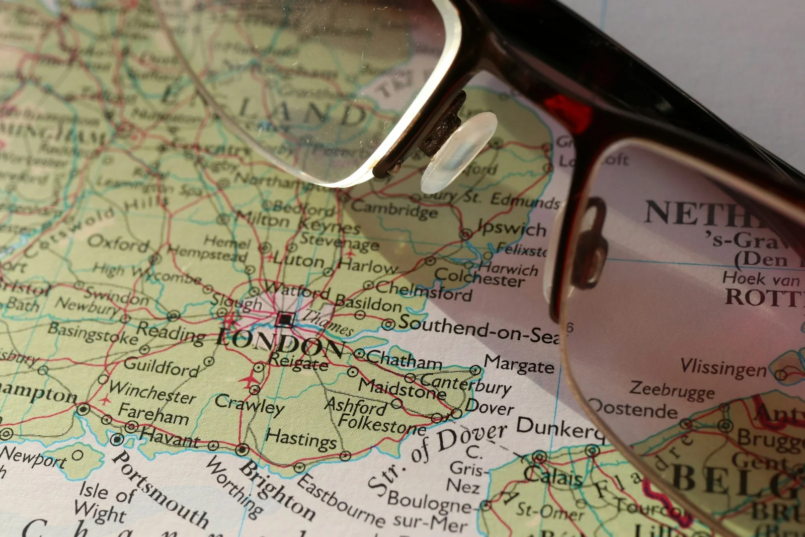 Glasses resting on a map of south-east England showing London and Essex